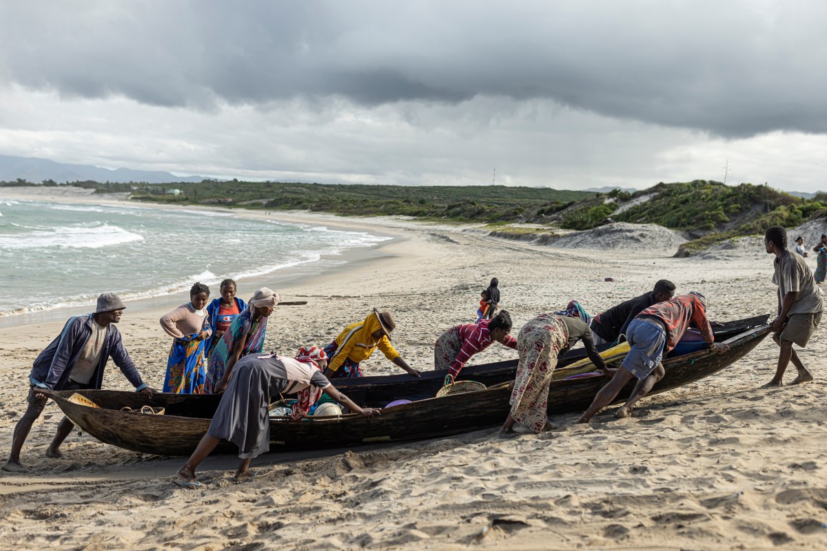 Fishermen push a fishing boat in Fort-Dauphin, Madagascar, on July 14, 2023.