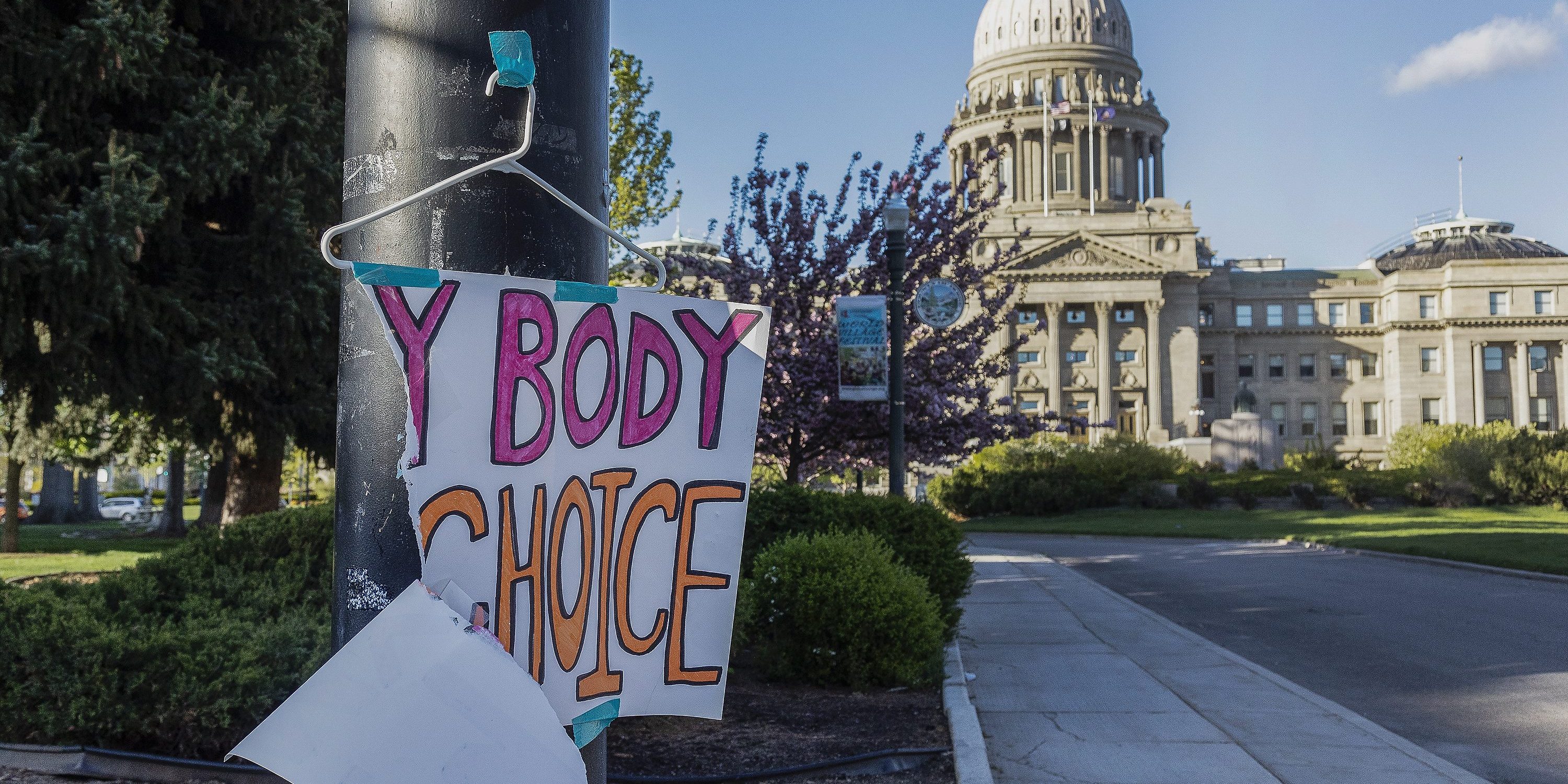 FILE - A sign reading "My body, my Choice," is taped to a hanger taped to a streetlight in front of the Idaho State Capitol Building on May 3, 2022. The Idaho Supreme Court ruled on Friday, Aug. 12, that the state's strict abortion bans will be allowed to take effect while legal challenges over the laws play out in court. (Sarah A. Miller/Idaho Statesman via AP, File)