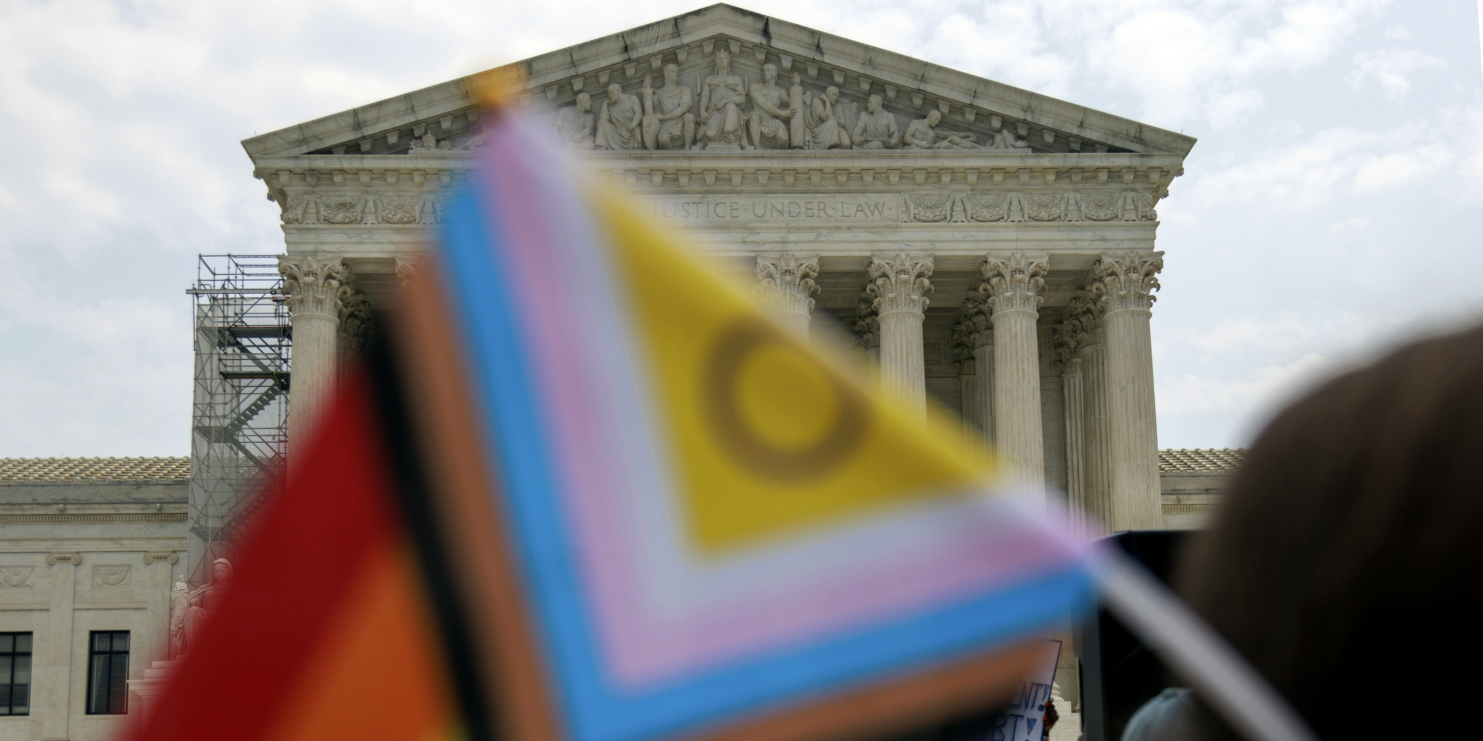 A demonstrator holds an Intersex-inclusive Pride Flag during a press conference outside of the Supreme Court in Washington, D.C. on June 30, 2023, after the Court rules against a case regarding LGBTQ protections and rules President Biden's student loan forgiveness program unconstitutional. (Photo by Bryan Olin Dozier/NurPhoto via AP)