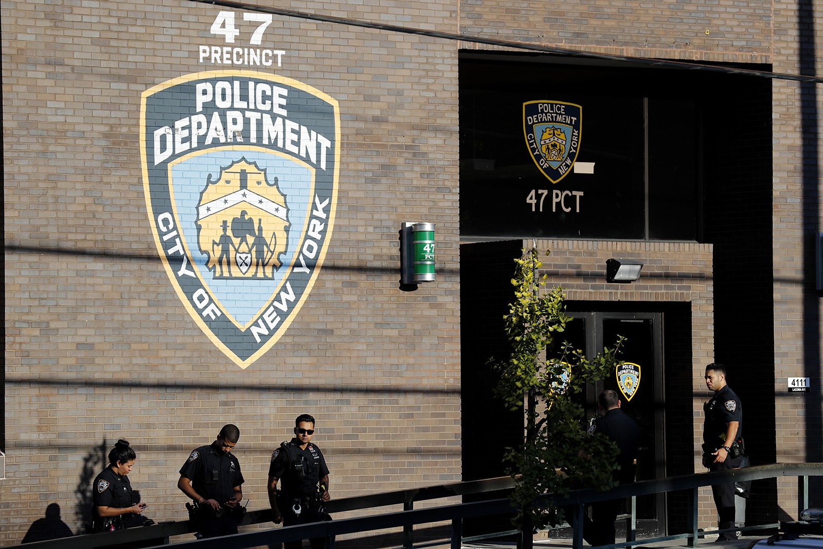 Police officers stand in front of the 47th precinct, near the scene of a fatal shooting of a New York City police officer in the Bronx borough of New York, Sunday, Sept. 29, 2019.  (AP Photo/Seth Wenig)