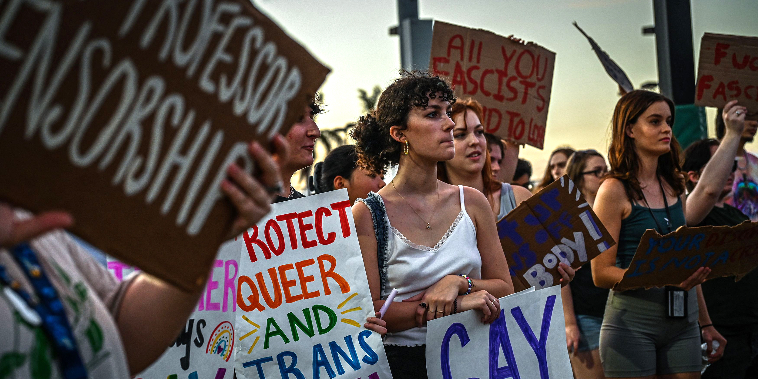 LGBTQ rights supporters protest against Florida Governor Ron Desantis outside a "Don't Tread on Florida" tour campaign event with Florida governor Ron DeSantis at the Alico Arena ahead of the midterm elections, November 6, 2022 in Fort Myers, Florida. (Photo by Giorgio VIERA / AFP) (Photo by GIORGIO VIERA/AFP via Getty Images)