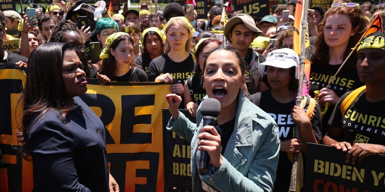 WASHINGTON, DC - JUNE 28: Rep. Cori Bush (D-MO) (L) and Rep. Alexandria Ocasio-Cortez (D-NY) rallying hundreds of young climate activists in Lafayette Square on the north side of the White House to demand that U.S. President Joe Biden work to make the Green New Deal into law on June 28, 2021 in Washington, DC. Organized by the Sunrise Movement, the 'No Climate, No Deal' marchers demanded a meeting with Biden to insist on an 'infrastructure package that truly invests in job creation and acts to combat the climate crisis.' (Photo by Chip Somodevilla/Getty Images)