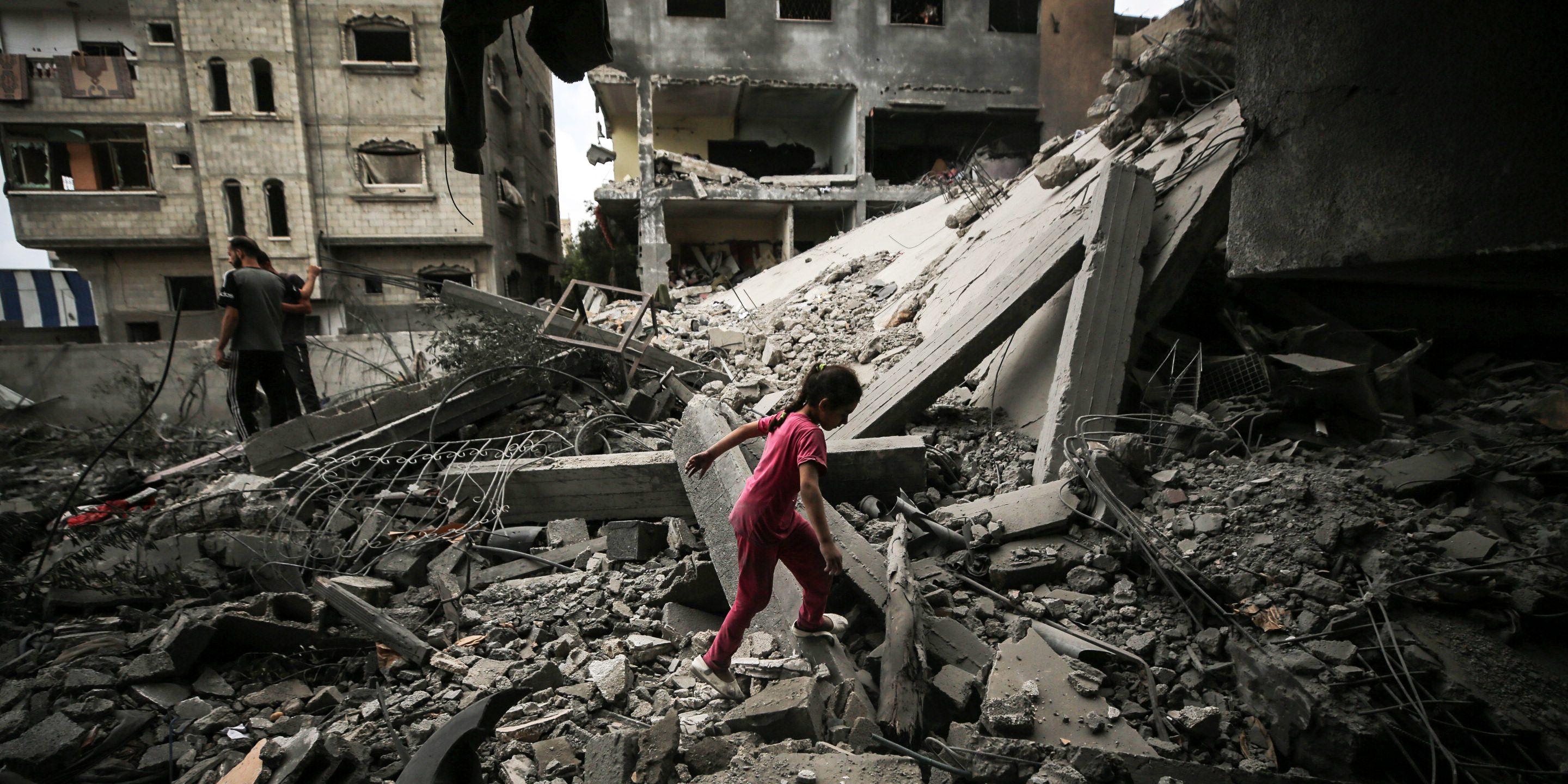 A Palestinian girl is walking over debris to get to a building a day after an operation by the Israeli Special Forces in the Nuseirat camp, in the central Gaza Strip, on June 9, 2024, amid the ongoing conflict between Israel and the Palestinian Hamas militant group. (Photo by Majdi Fathi/NurPhoto via Getty Images)