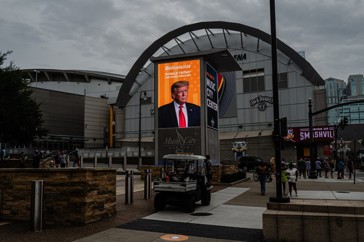 NASHVILLE, TENNESSEE - JULY 27: Former President Donald Trump's photograph is seen on a digital display outside of the venue ahead of his afternoon keynote speech on the final day of the Bitcoin 2024 conference at Music City Center July 27, 2024 in Nashville, Tennessee. The conference, which is aimed at bitcoin enthusiasts, features multiple vendor and entertainment spaces and seminars by celebrities and politicians. (Photo by Jon Cherry/Getty Images)