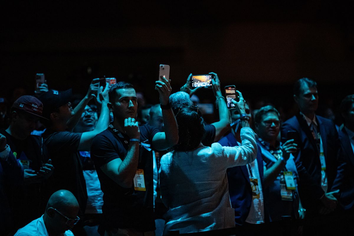 NASHVILLE, TENNESSEE - JULY 27: Attendees record and spectate as Former President Donald Trump gives a keynote speech on the third day of the Bitcoin 2024 conference at Music City Center July 27, 2024 in Nashville, Tennessee. The conference, which is aimed at bitcoin enthusiasts, features multiple vendor and entertainment spaces and seminars by celebrities and politicians. (Photo by Jon Cherry/Getty Images)