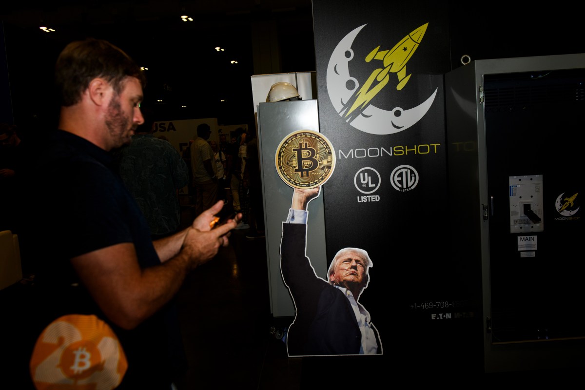 A sign featuring Former US President Donald Trump on a Moonshot booth during the Bitcoin 2024 conference in Nashville, Tennessee, US, on Friday, July 26, 2024. The conference is an annual event organized by BTC Media LLC for fans of the original cryptocurrency. Photographer: Liam Kennedy/Bloomberg via Getty Images